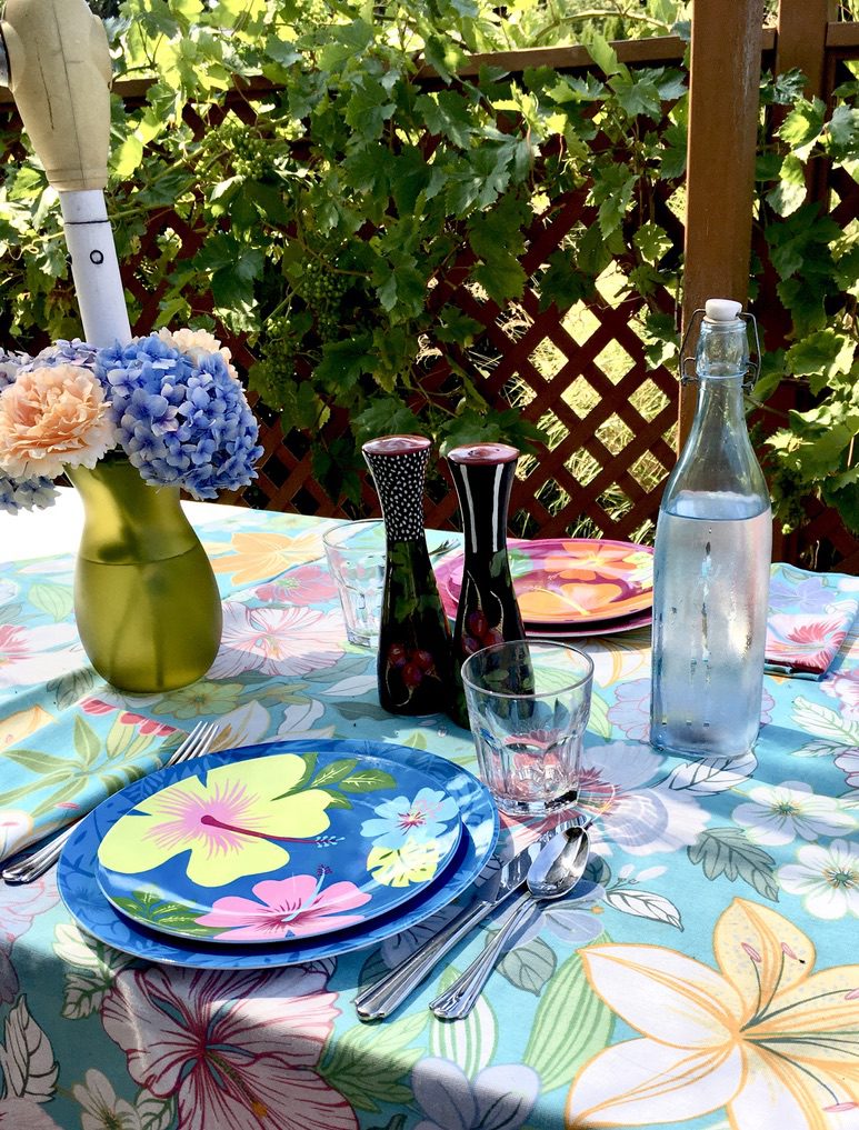 a dining table with floral decorations and plates